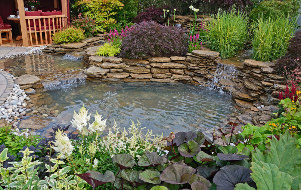 What Are the Most Durable Materials for a Garden Pond Backsplash?